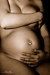 pregnancy - pregnant woman holding belly with navel ring