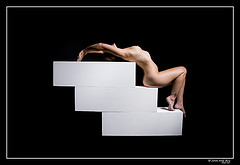 art nude - nude woman laying on stairs